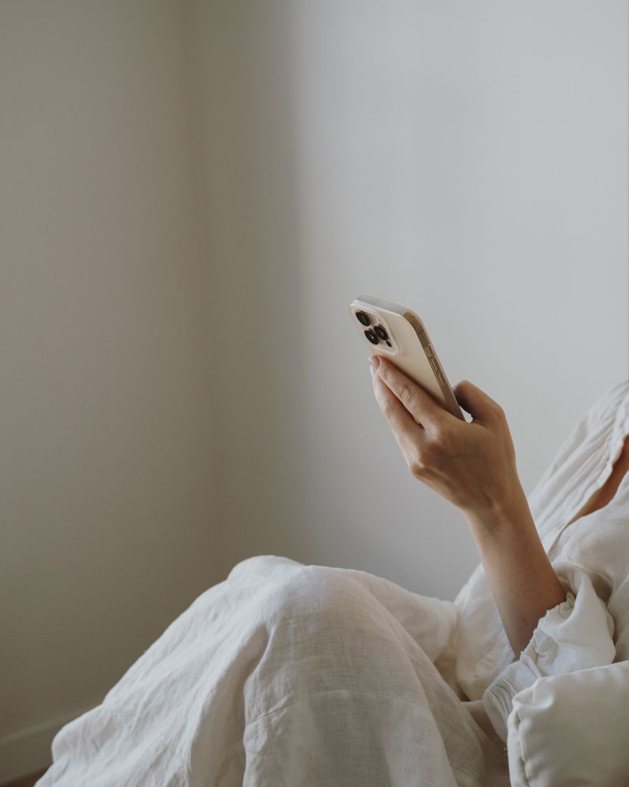A hand holding a phone, ready to film a reel